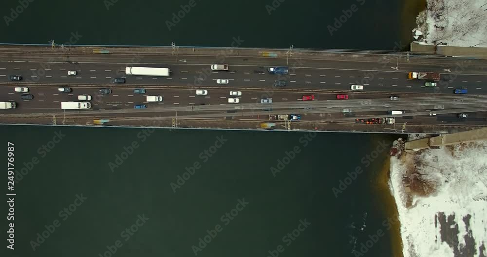 Aerial Bridge Car Traffic Top Down Shot.Aerial Top Down View Traffic Jam On A Car Bridge.Aerial Car Rush Hour From Drone View. Top Down Aerial View To A Bridge.Aerial View Of Traffic Crossing Bridge. 