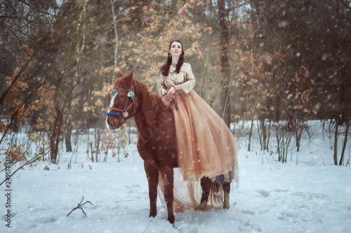 Woman riding a horse in the winter forest.
