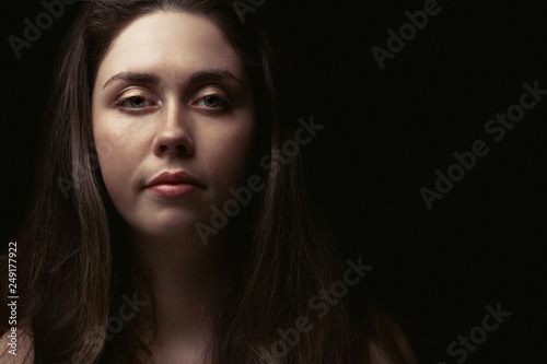 portrait of beautiful girl on black background with copy space