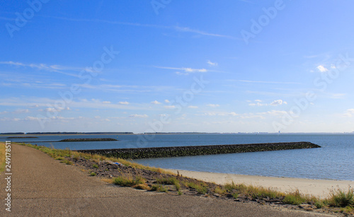 three piers in the river scheldt with high tide in summer
