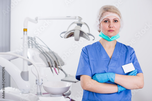 Female dentist with hands crossed