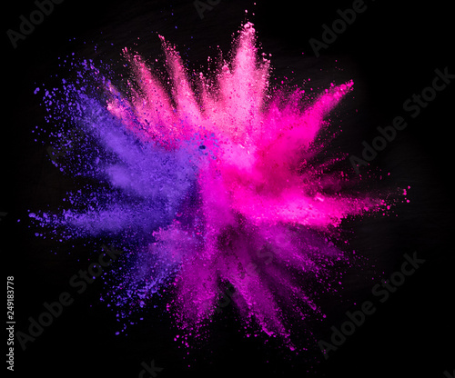 Explosion of colored powder on black background