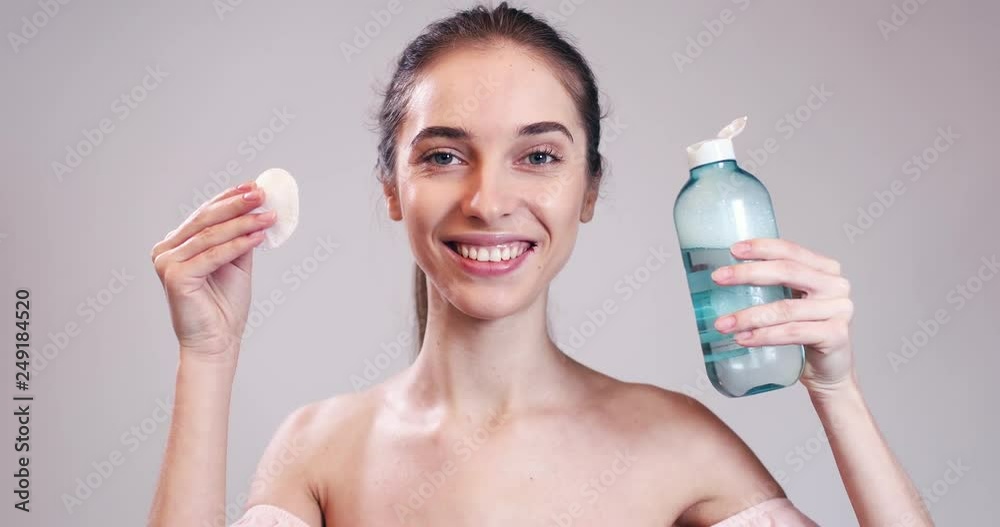 Girl holding cotton pad and bottle of water for face Cleaning Girl holding cotton pad and bottle of water for face Cleaning