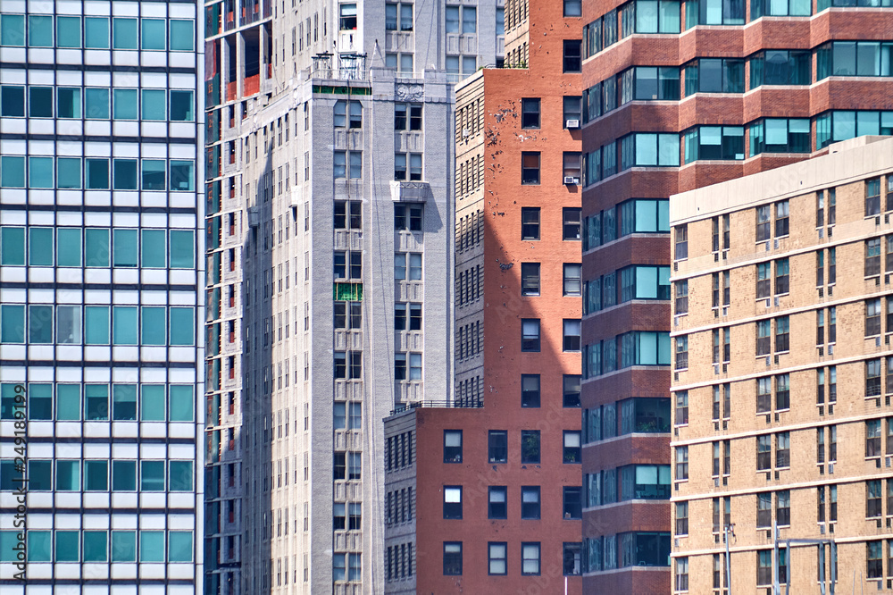 A group of tall buildings next to each other, very colorful and with many windows creating a kind of a pattern