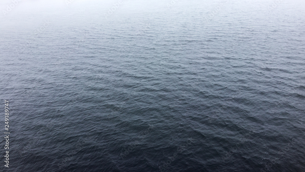 water surface in the fog. small ripples on the water. background water surface in the fog. small ripples on the water. background