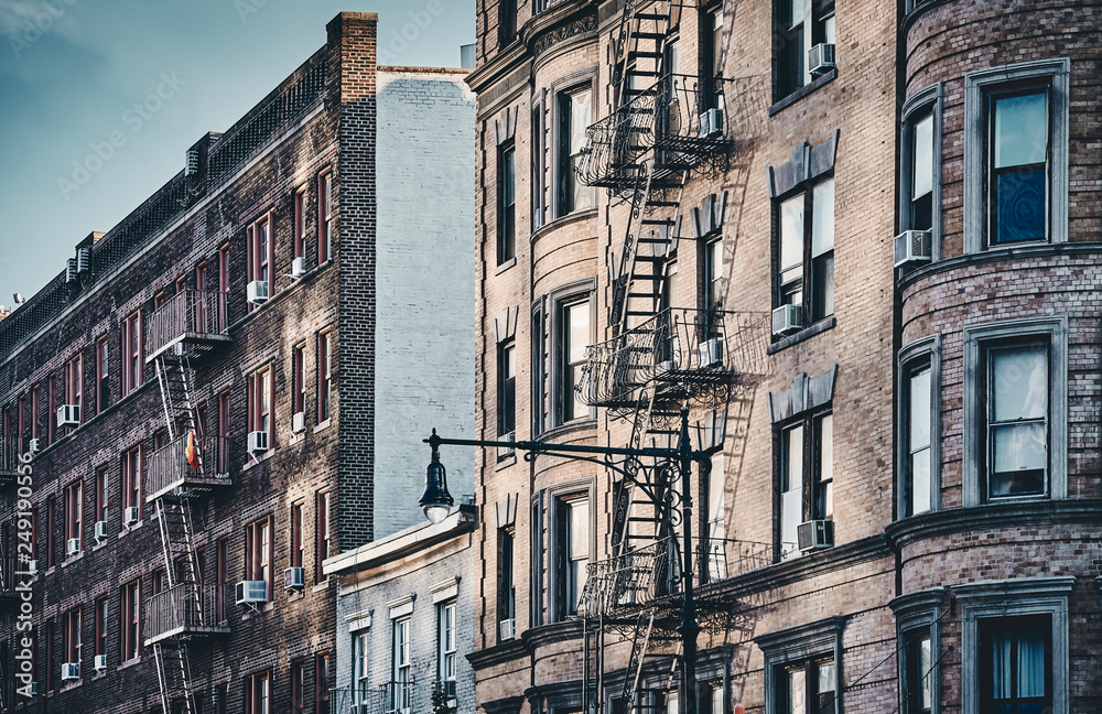 New York old buildings with fire escapes, color toned picture, USA.