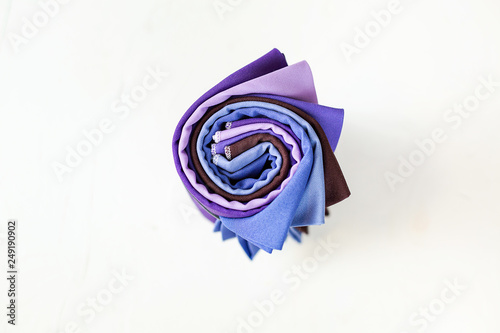 Rolled up colorful fabric swatches on white background photo