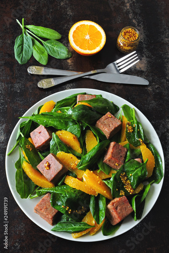 Salad with spinach, orange and smoked salmon. Paleo diet, keto diet, pegan diet. Healthy fitness salad with spinach and fish.