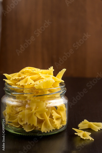 Delicious traditional farfalle Italian macaroni pasta in the glass jar