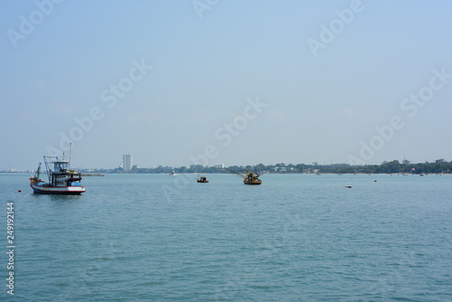 Close-up photos of small fishing boats at the fishing fishing port, Bang Saray Subdistrict, Sattahip District, Chonburi Province. Fishing boat view, sky and sea on a bright day photo