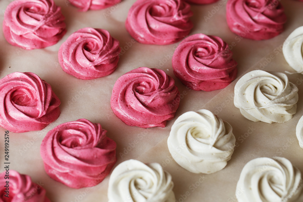 The process of making zephyr marshmallow at pastry shop kitchen. Fresh white and pink fruit marshmallow roses. The process of making zephyr marshmallow at pastry shop kitchen. Fresh white and pink fruit marshmallow roses.