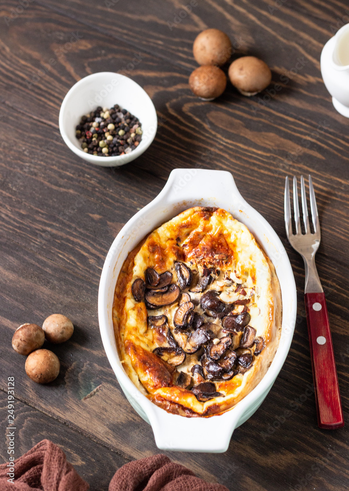 Fresh homemade omelette with mushrooms and cheese on dark wooden background. Rustic style. Top view. Fresh homemade omelette with mushrooms and cheese on dark wooden background. Rustic style. Top view.