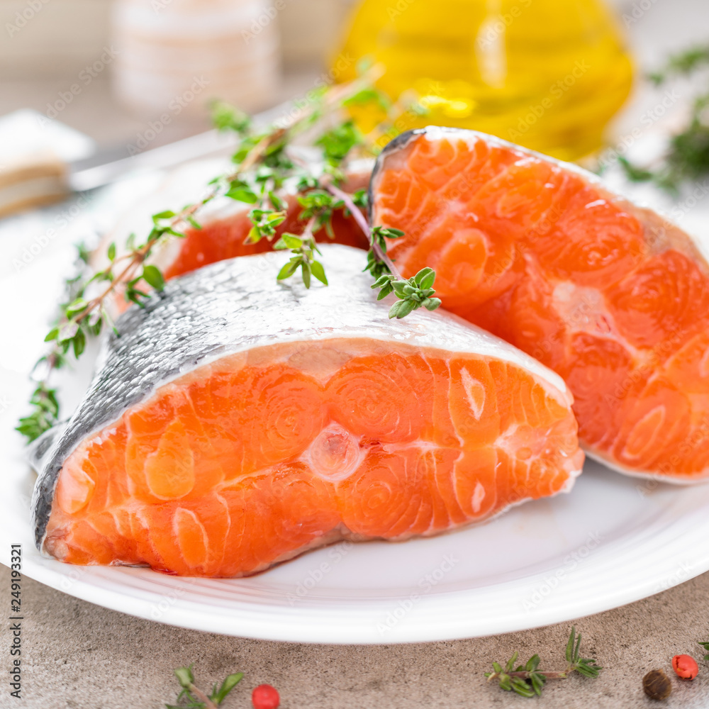 Fresh raw salmon fish steaks on white kitchen background Fresh raw salmon fish steaks on white kitchen background
