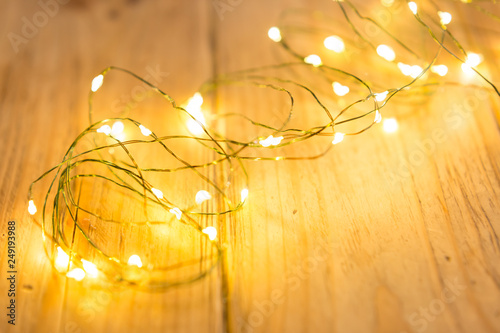 background texture. garland on boards. glowing light bulbs. Christmas garland