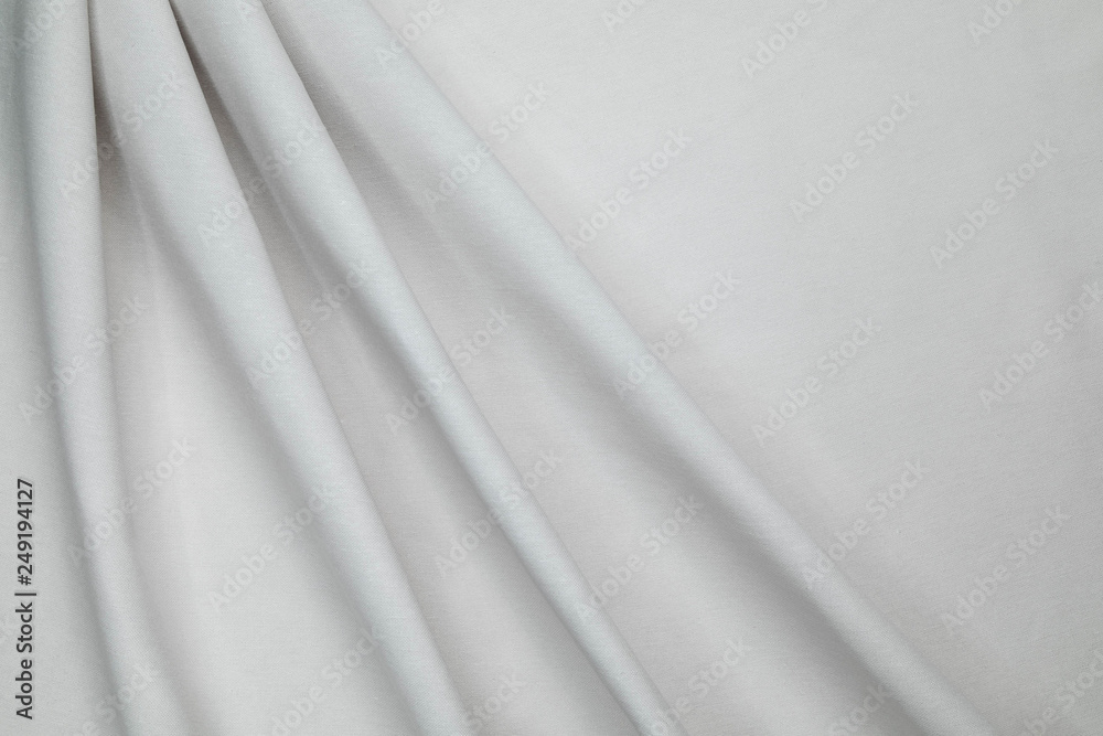 Rough homespun white color fabric is laid by diagonal soft folds