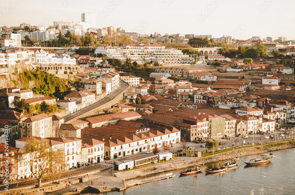 Porto cityscape with red roofs and river while sunset