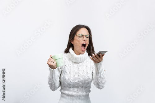 beautiful young woman in a studio shouting on a cell phone