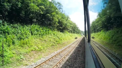 Train ride timelapse, recording outside the window of a train. Serra do Mar Paranaense, between the cities of Curitiba and Morretes. Passing through tunnels, green vegetation, hills, bridge on nature photo