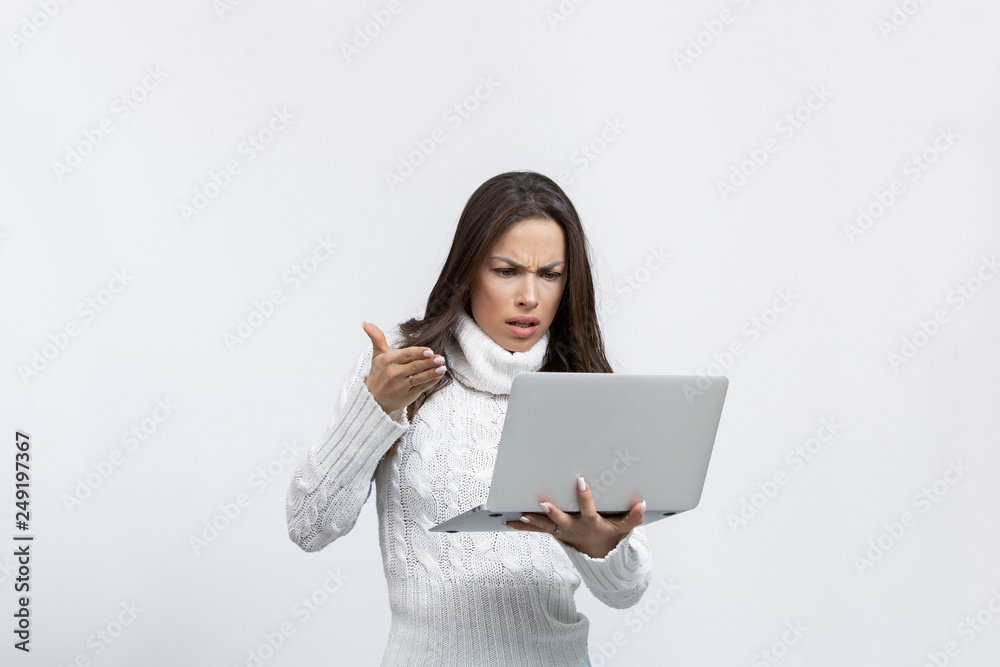 beautiful young woman mad in a studio with a laptop beautiful young woman mad in a studio with a laptop