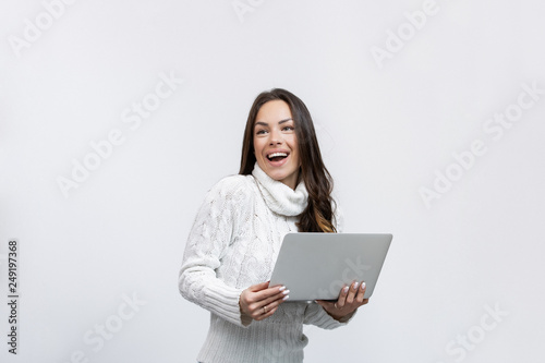 beautiful happy young woman in a studio with a laptop © Etoilestars