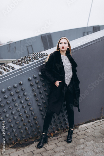 Industrial street urban portrait of young blondie caucasian beautiful girl. Architecture, beauty concept photo