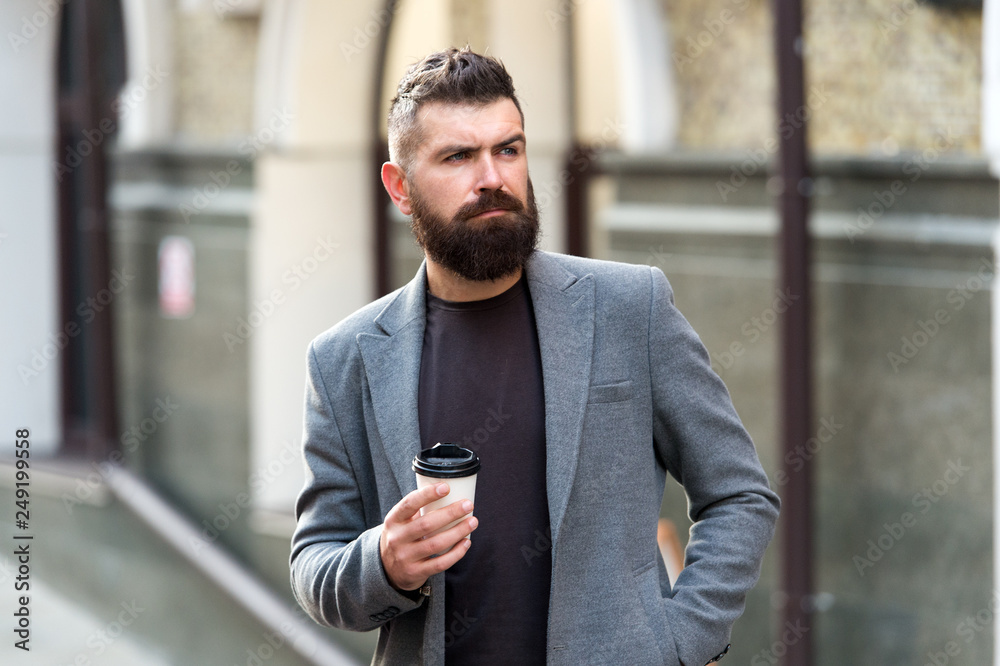 Enjoying coffee on the go. Businessman well groomed appearance enjoy coffee break out of business center. Relax and recharge. Man bearded hipster drinking coffee paper cup. One more sip of coffee Enjoying coffee on the go. Businessman well groomed appearance enjoy coffee break out of business center. Relax and recharge. Man bearded hipster drinking coffee paper cup. One more sip of coffee