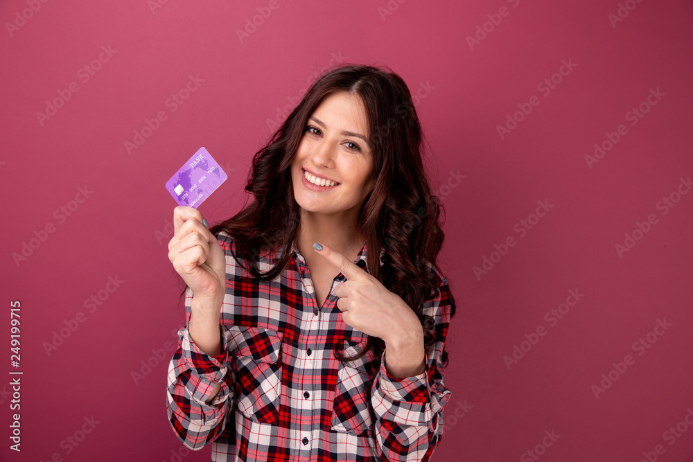 Smiling young woman holding credit card. isolated portrait. Smiling young woman holding credit card. isolated portrait.