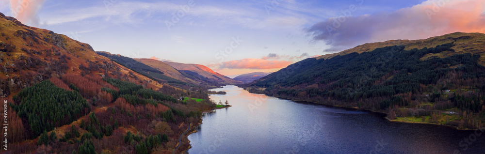 Scottish beautiful colorful sunset landscape with Loch Voil, mountains and forest at Loch Lomond & The Trossachs National Park