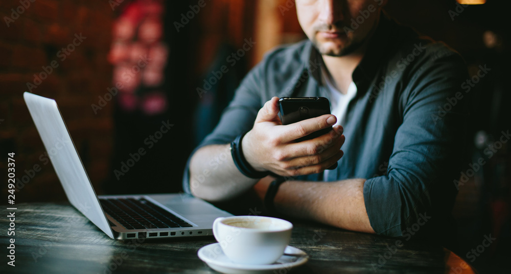 young man  working in cafe and drink black coffee