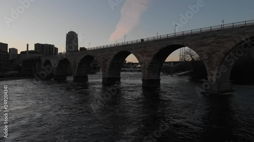 Stone arch bridge Minneapolis Minnesota, view from the Mississippi river photo