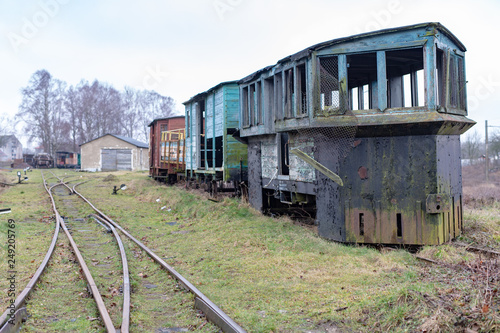 Old rusty wagon of the narrow gauge railway. Place of stationing of old steam locomotives.
