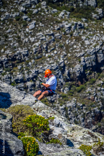 A daring European tourist rock climbing in Cape Town South Afric