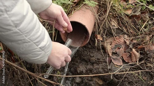 Collecting drain pipe water sample with test tube photo