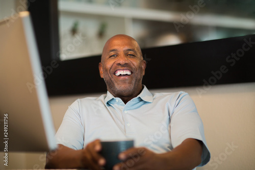 Mature African American man working from his home office.