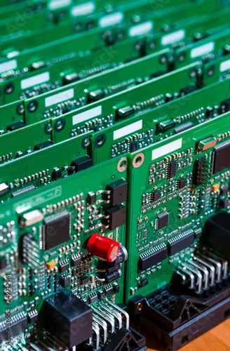 Fototapeta Naklejka Na Ścianę i Meble -  Microelectronics Industry and Manufacturing. Stack of Produced  Printed Circuit Boards with Surface Mounted Components.