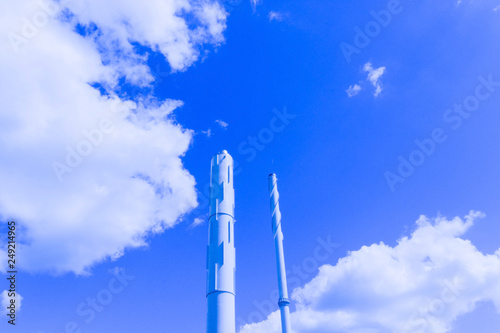 Factory pipes and blue cloudy sky. Air poluttion concept photo