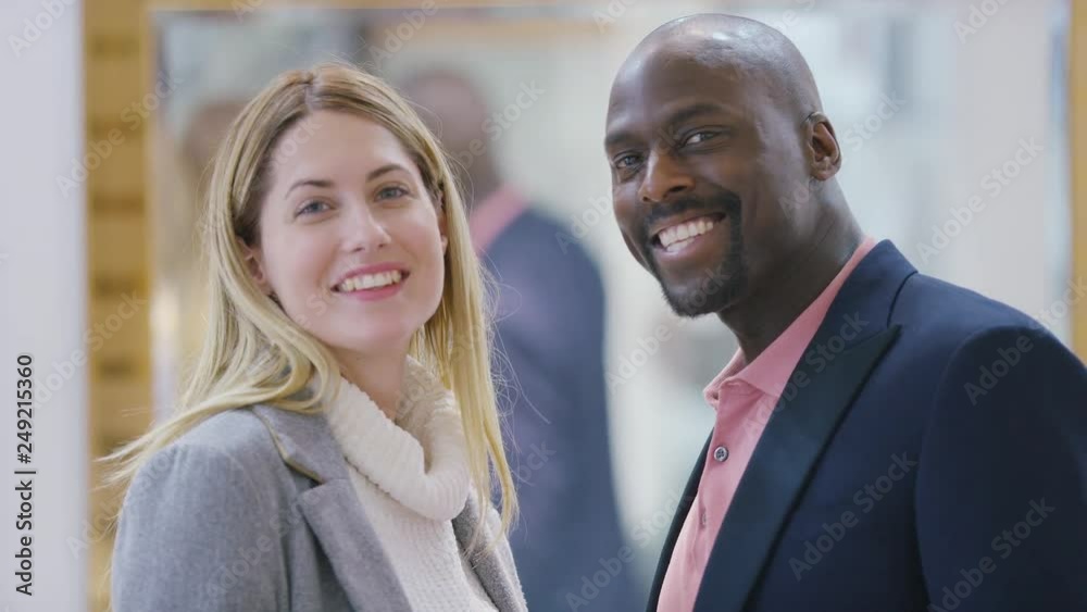 Portrait of diverse couple turning and smiling to camera Portrait of diverse couple turning and smiling to camera