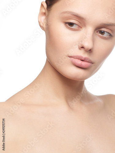 Beauty portrait of young girl with brown hair and big lips on white background with clean face skin and arm near head. Good for cosmetic, medicine and spa . European type