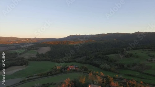 Aerial drone video at sunset time above an ancien building at the top of the hill in the countryside of Piacenza, Italy, near Pianello Val Tidone. photo