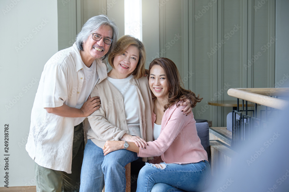 Happy family hugging and teasing to each other while photographed. Happy family hugging and teasing to each other while photographed.