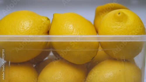 Detox drink. Healthy food concept. Juicy fruits for souce, salad dressing, seasoning. Sour lemon taste. Yellow lemons keeping freshness in fridge. Fresh yellow lemons in icebox. Copy space.