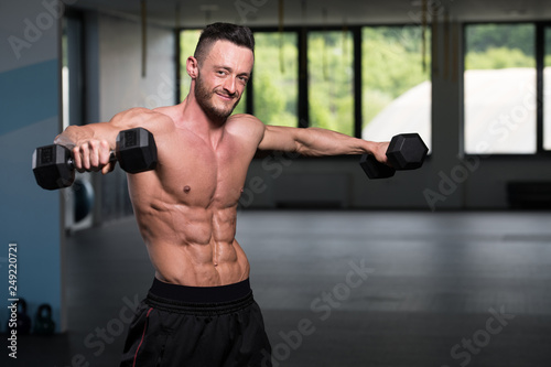 Man With Dumbbells Exercising Shoulders