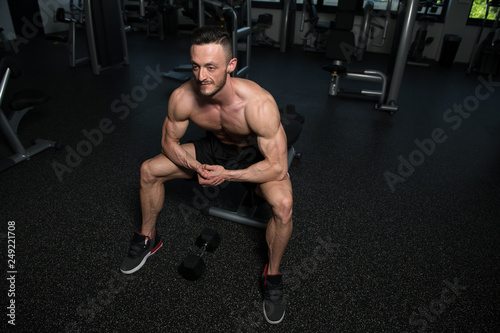 Attractive Young Man Resting In Gym Afther Exercise photo