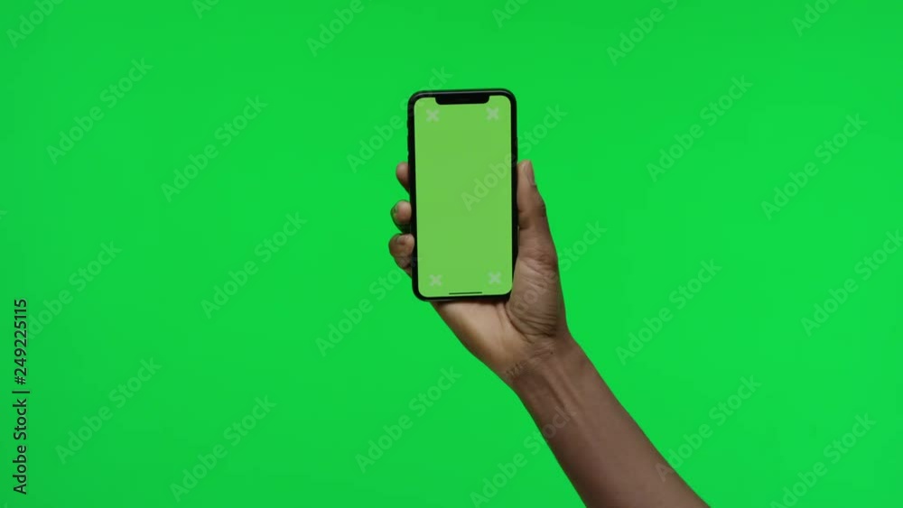 Female hand holding smart device on green screen chroma background making gestures, zoom in, pinch, swipe, scroll Female hand holding smart device on green screen chroma background making gestures, zoom in, pinch, swipe, scroll
