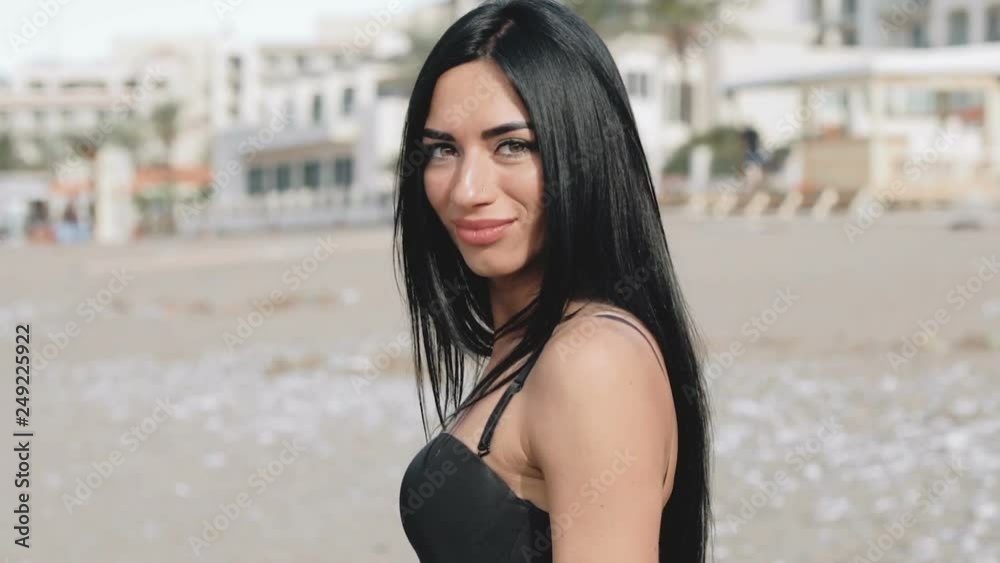 Beautiful girl shyly smiles and looks into the camera
