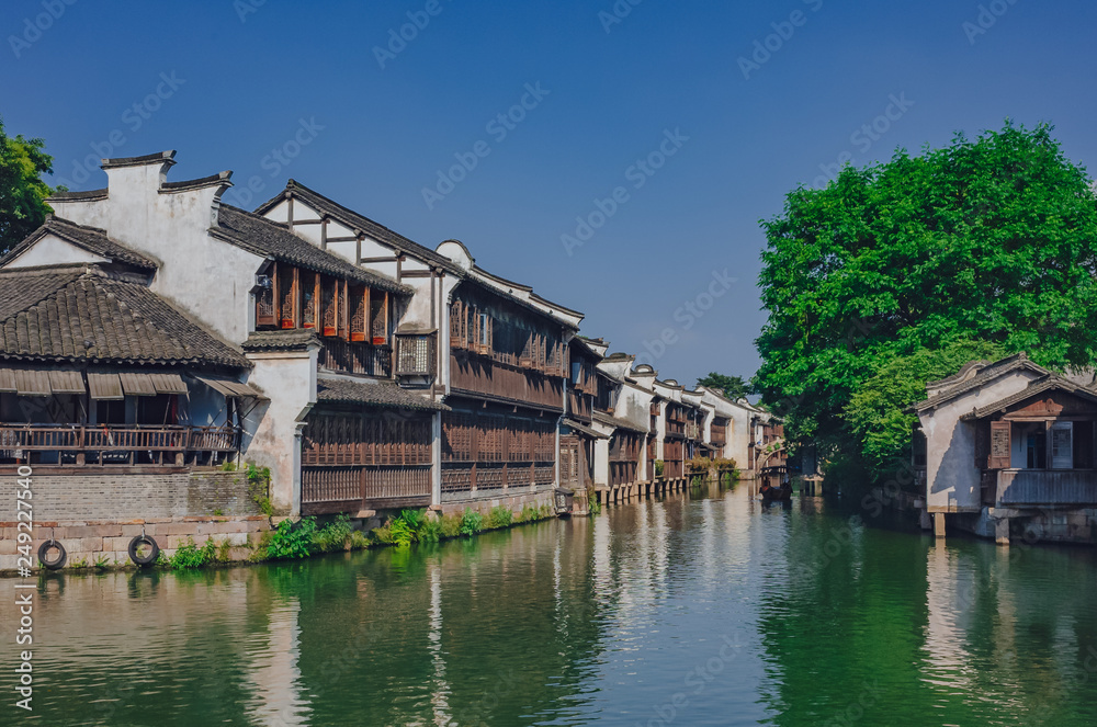 Traditional Chinese houses and trees by water, in the old town of Wuzhen, China Traditional Chinese houses and trees by water, in the old town of Wuzhen, China