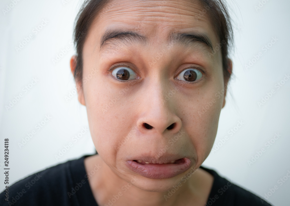 Asian woman looking surprised and scared - funny. Isolated on white background. Asian woman looking surprised and scared - funny. Isolated on white background.