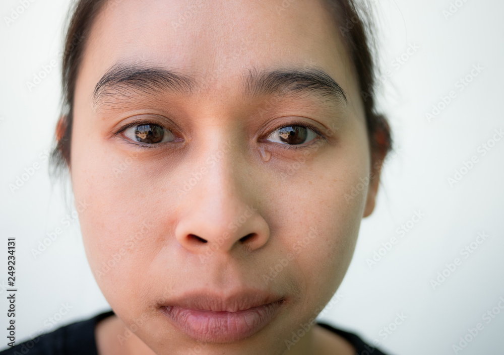 Close-up portrait of Asian woman looking sick face on white background. Close-up portrait of Asian woman looking sick face on white background.