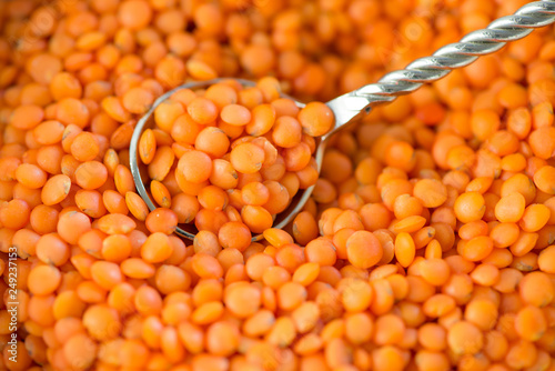 Closeup of red lentil with metallic spoon