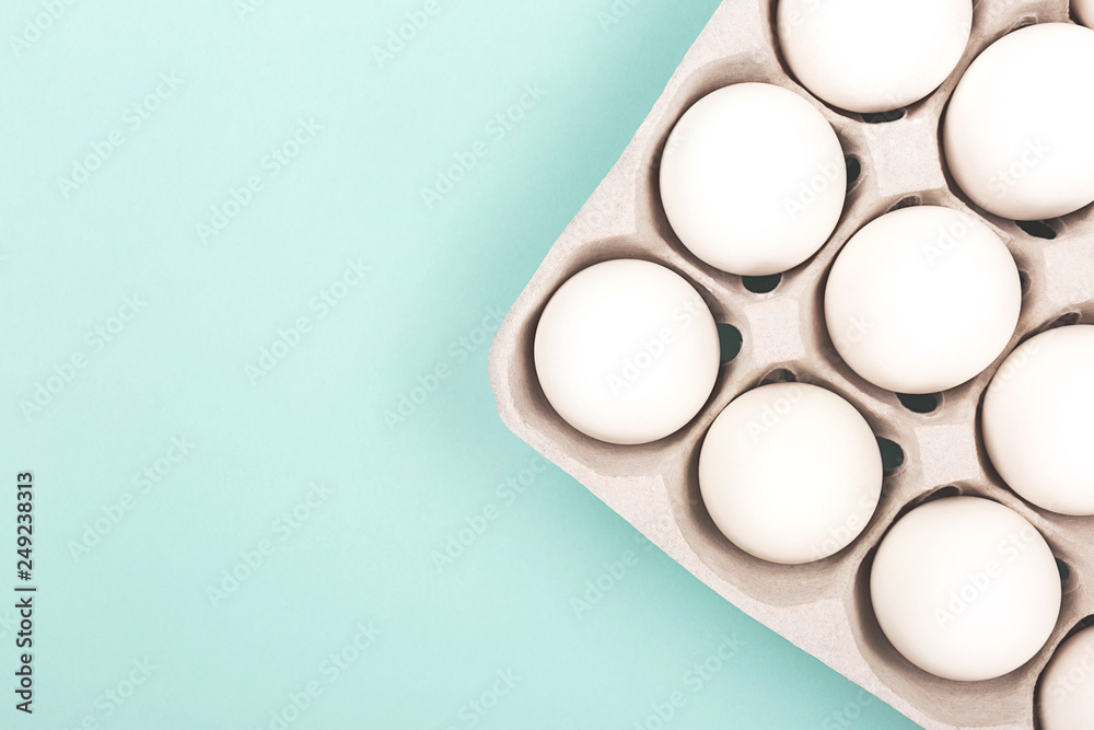 Eggs in egg box on mint background
